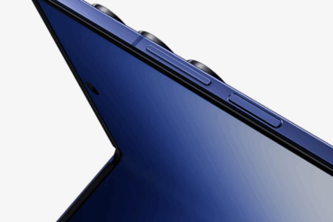 Nærbilde av en blå Samsung-mobil sett fra siden, med fokus på den tynne profilen, rammen og de fysiske knappene langs kanten.