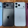 Fire iPhone 18 Pro dummies i ulike farger ligger på rekke ved siden av hverandre med baksiden opp på en treoverflate.