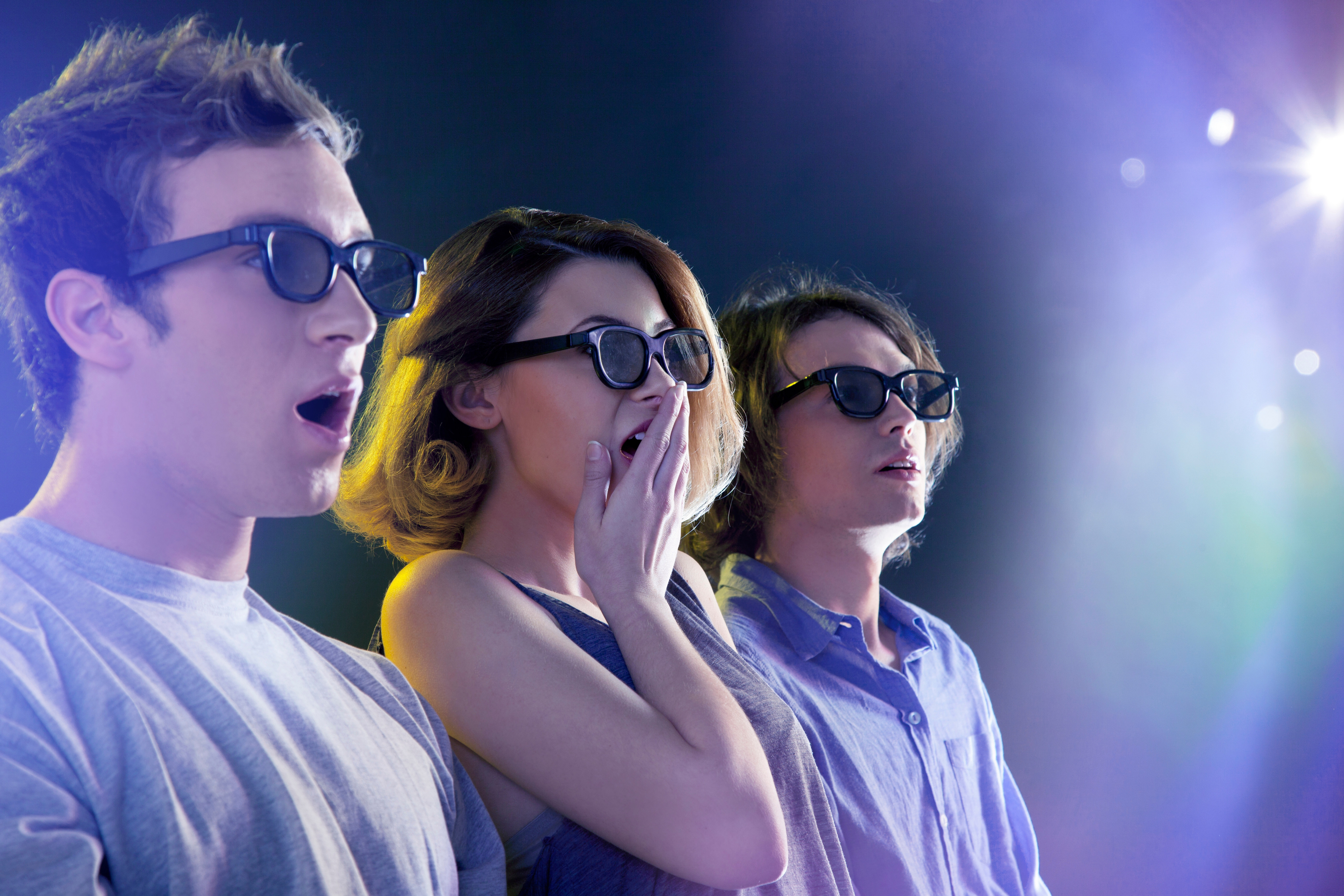 People in 3D glasses looking towards light